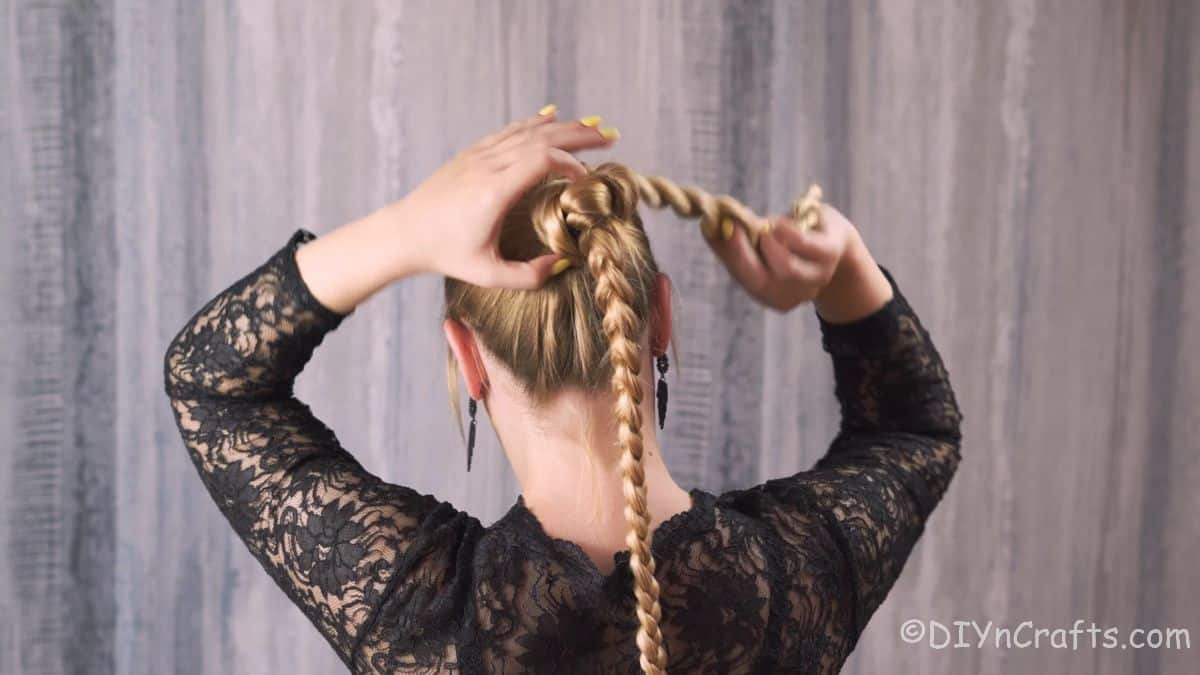 two twisted rope braids being wrapped around bun