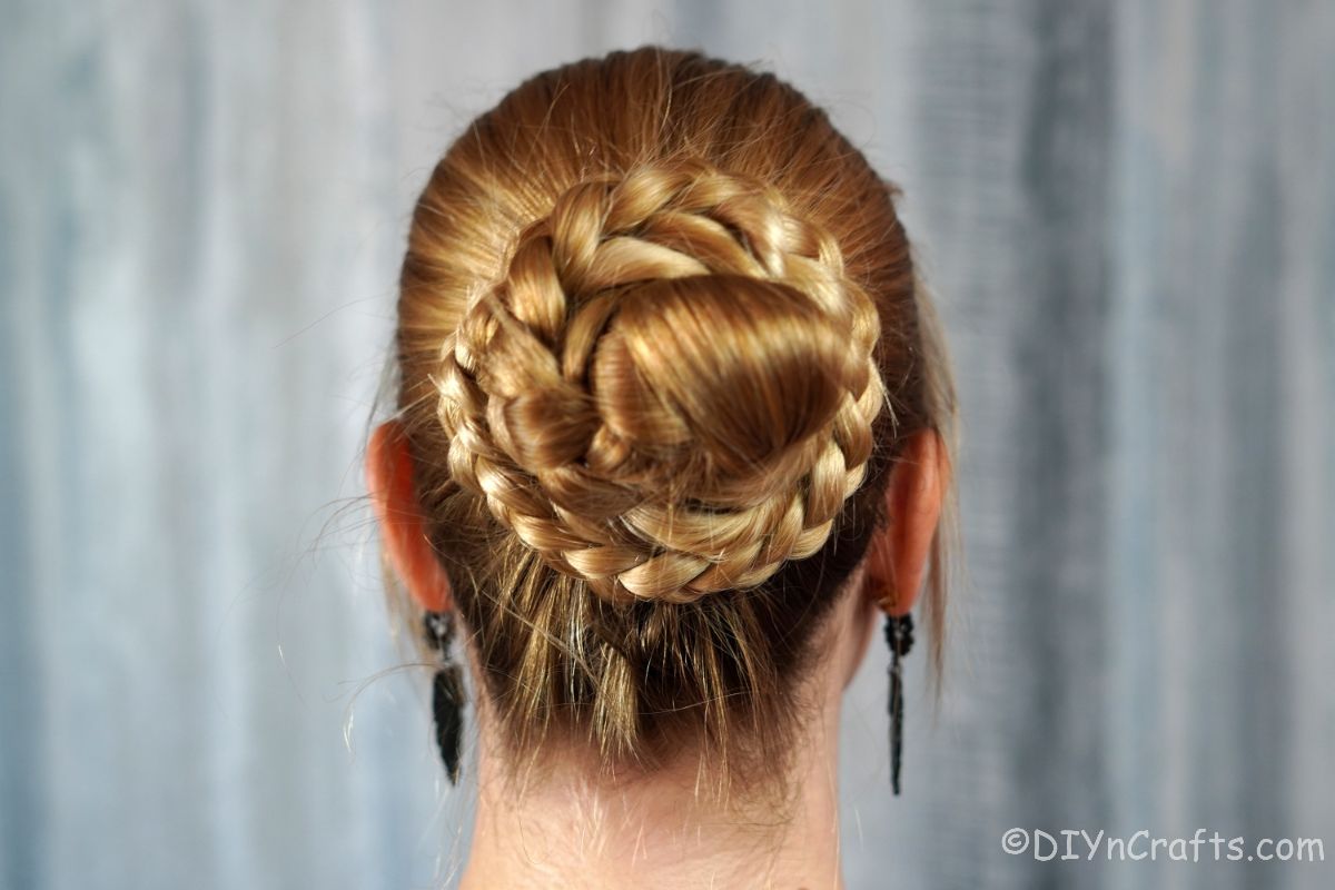 woman with blonde hair into a twisted braid bun