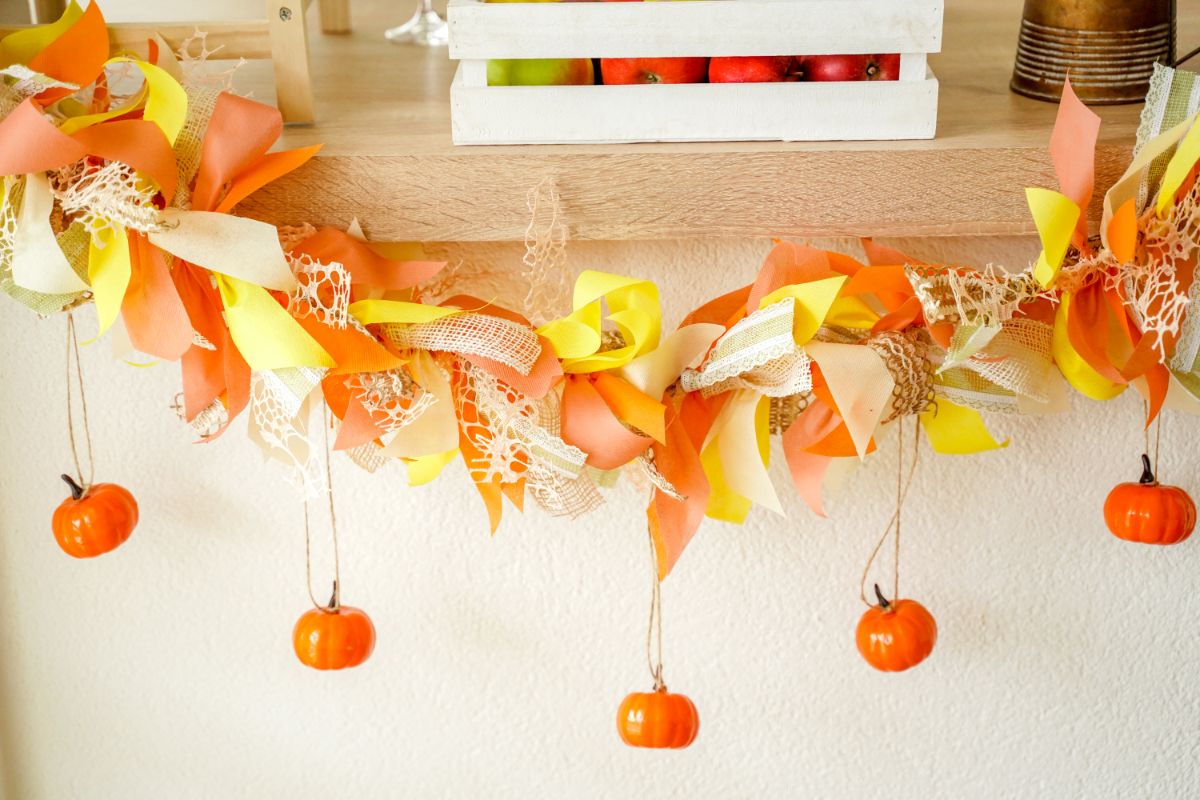 fall rag garland with fake pumpkins hanging down