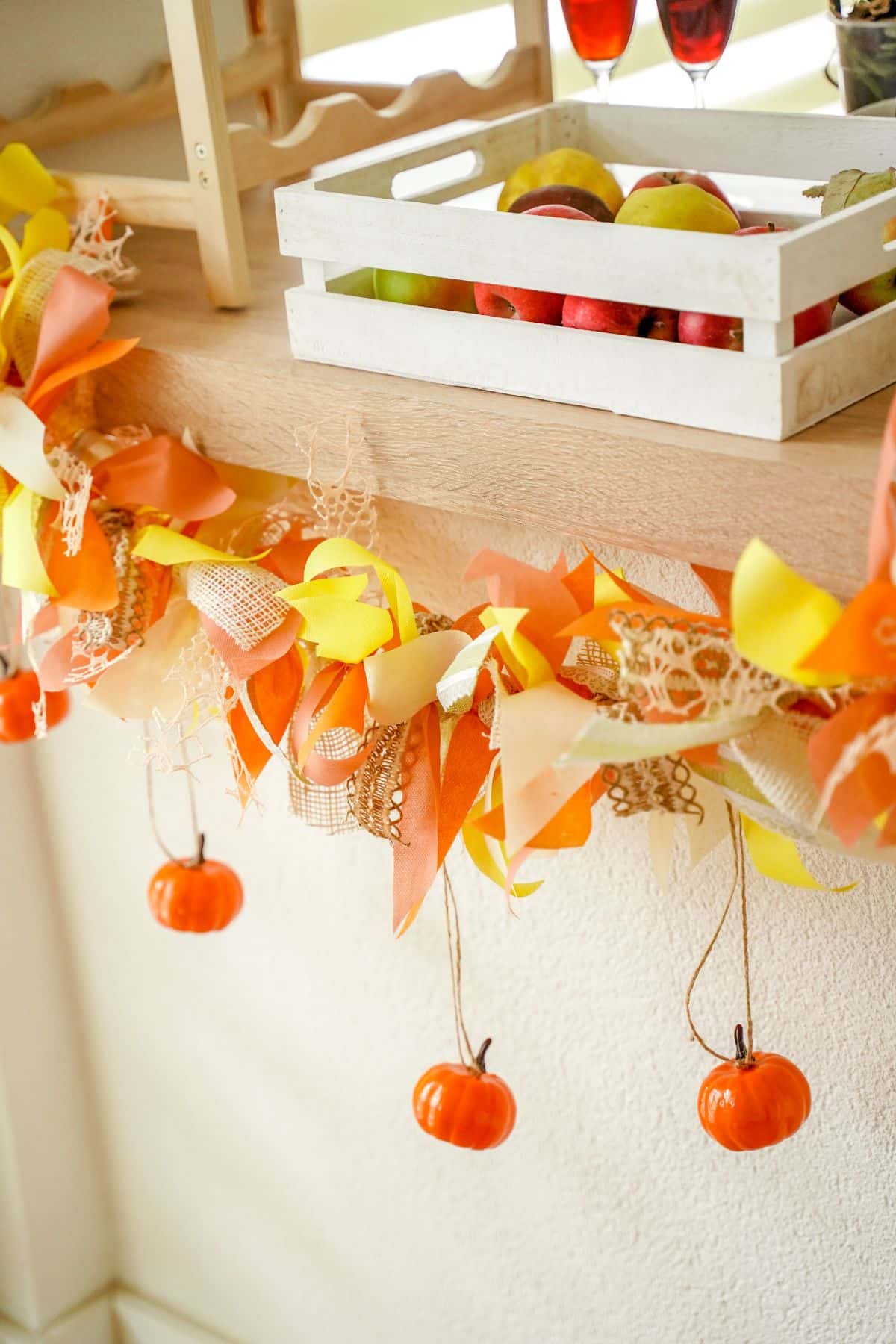 pumpkins hanging down from fall garland