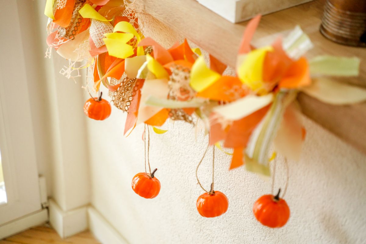 mini pumpkins hanging down from fall rag garland