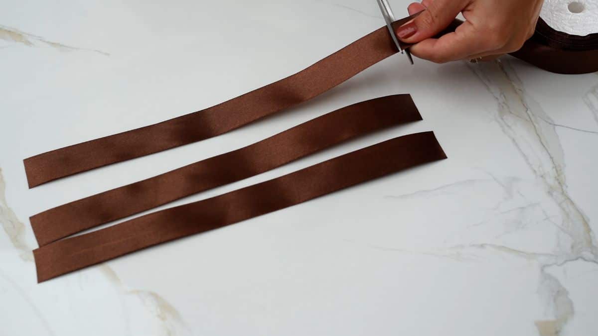 cutting lengths of brown ribbon