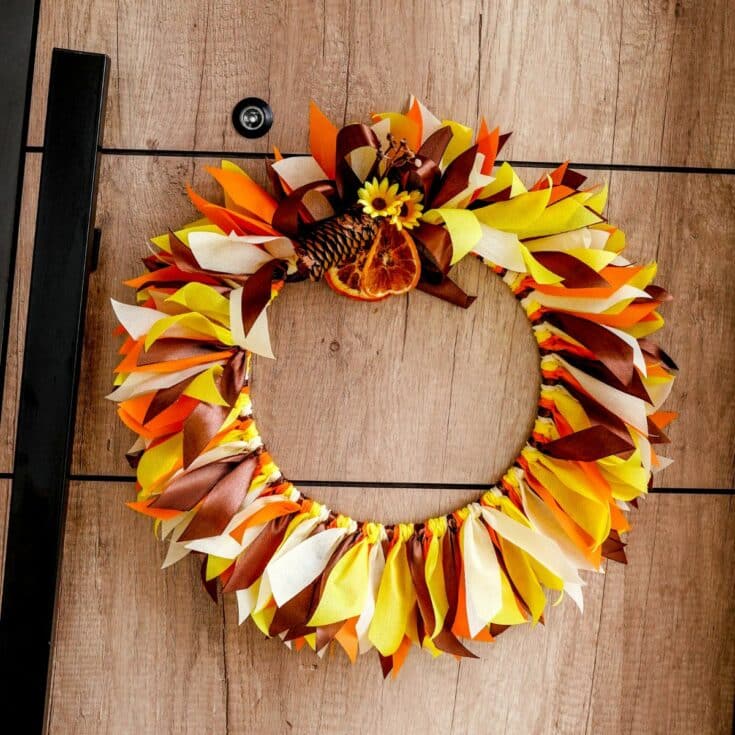 fall rag wreath hanging on wood wall