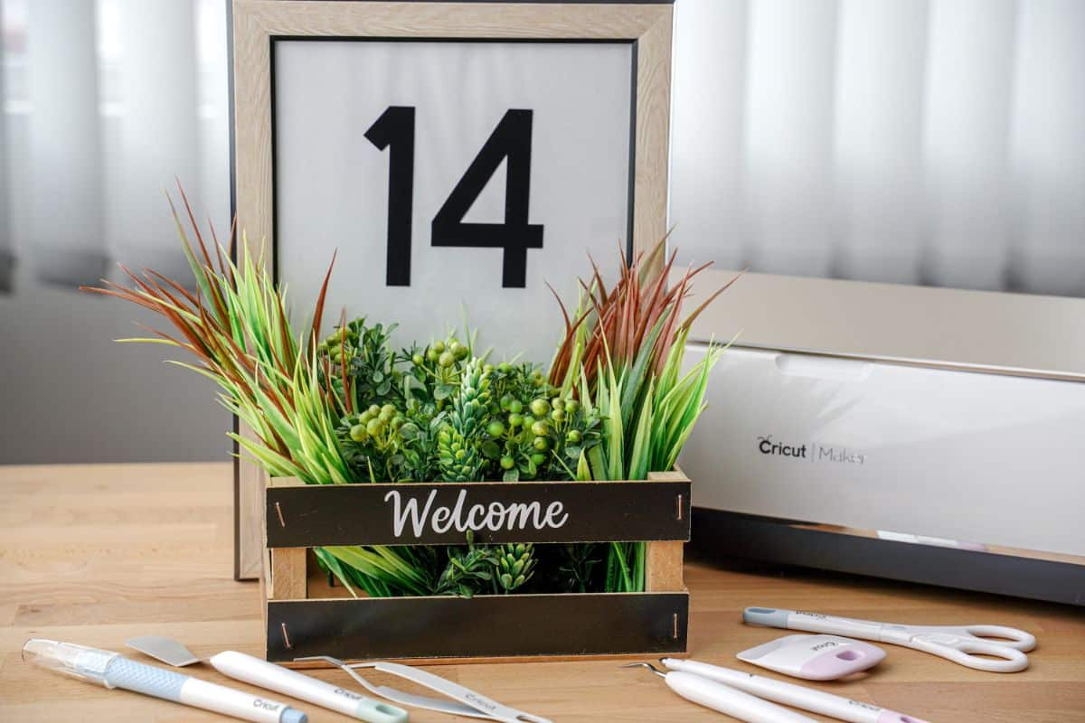 house number sign sitting beside Cricut maker on table