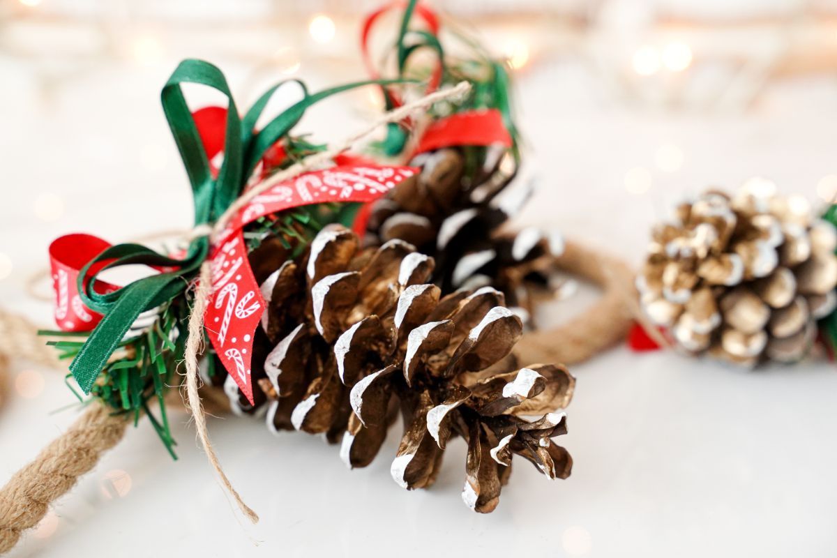 red and green ribbon bows on pinecone ornaments