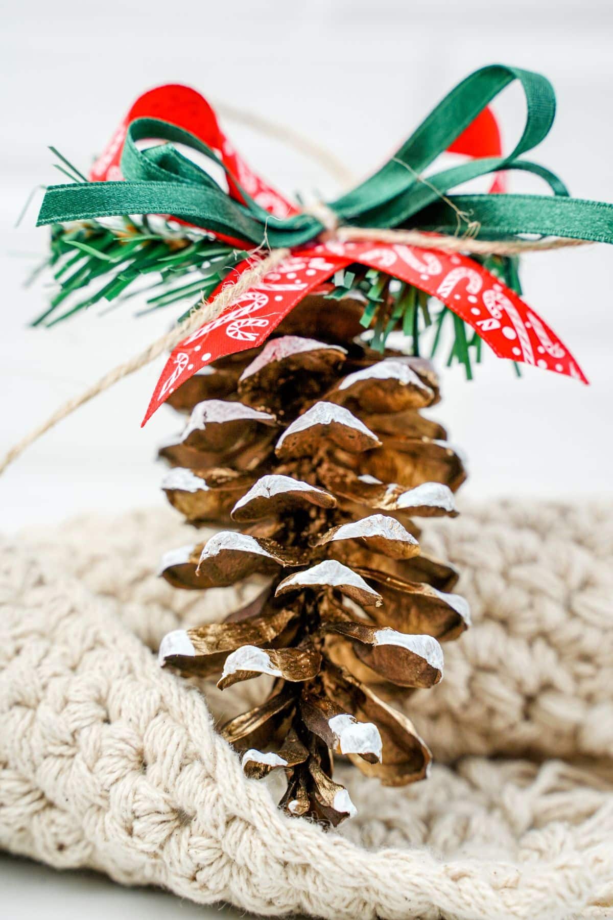 pinecone ornament on cream blanket