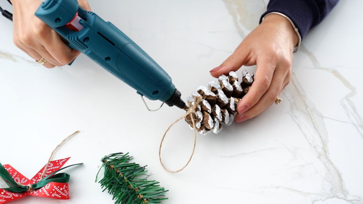 gluing twine hanger to ornament