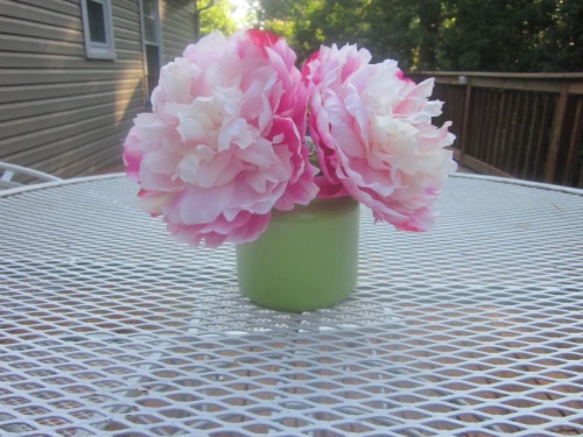 A candle jar repurposed as a vase.