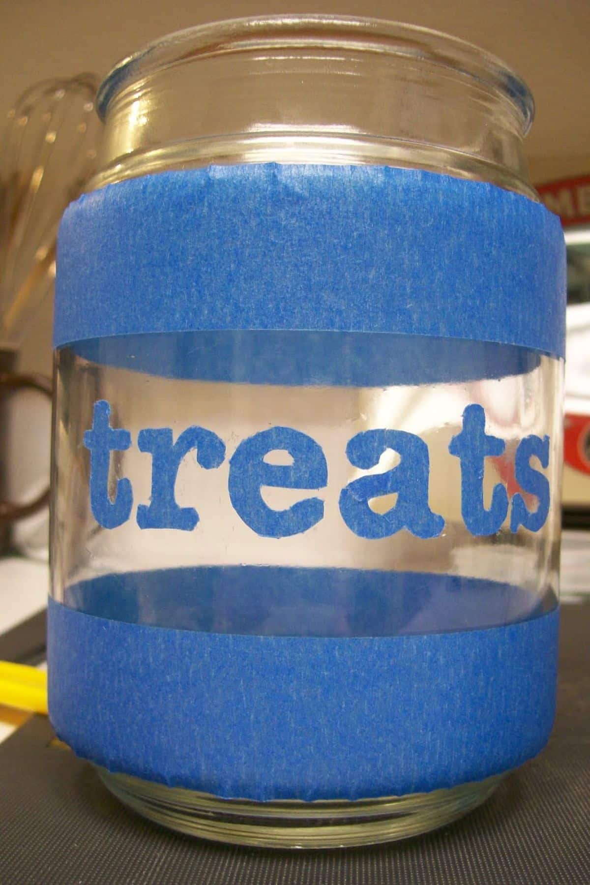 A repurposed candle jar as a treat jar,