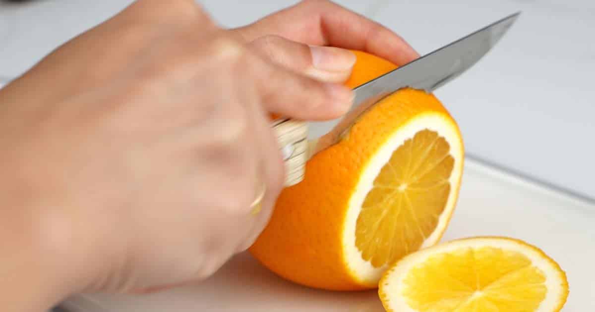 slicing oranges to make a dried orange garland