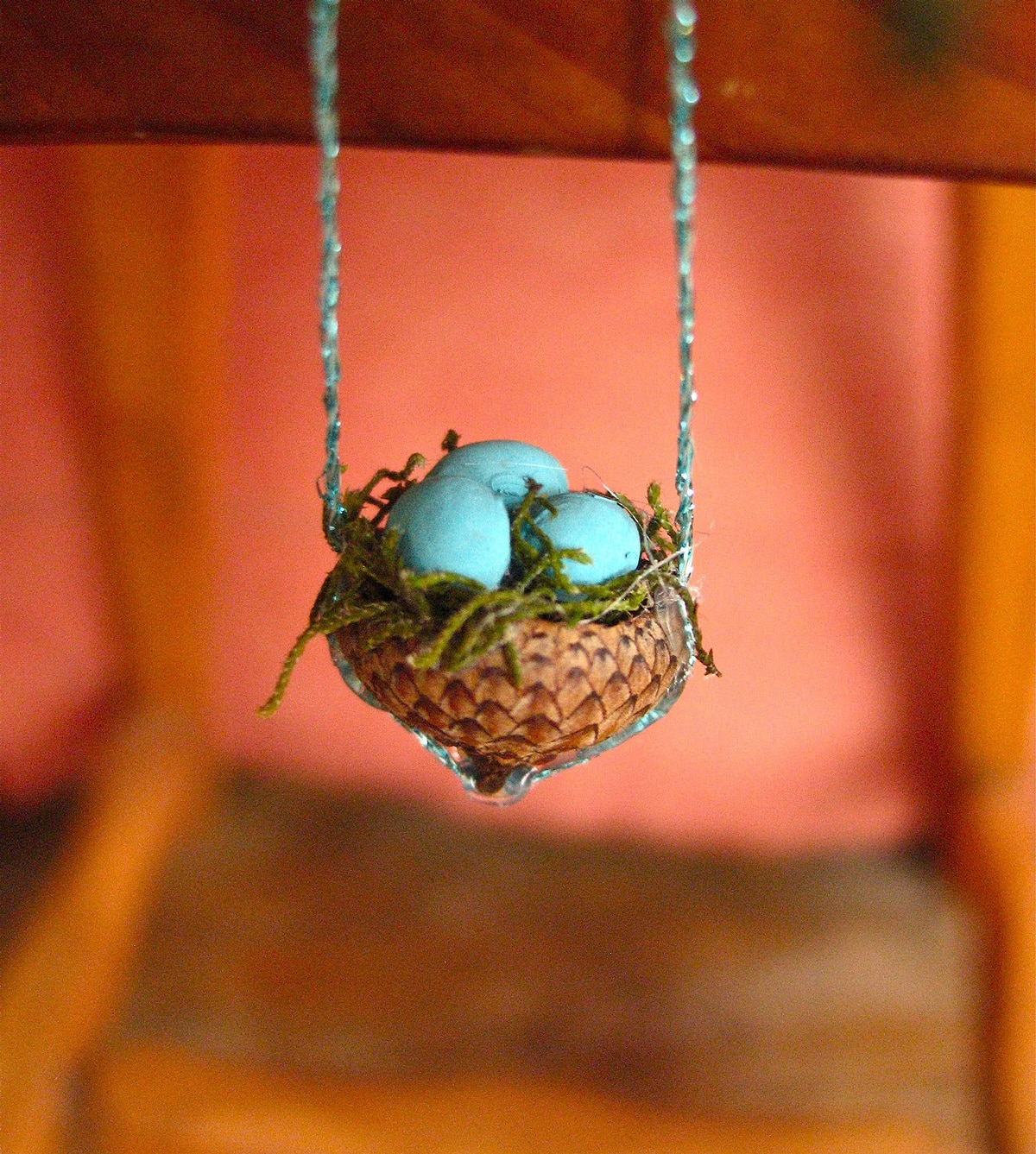 bird's nest necklace has three eggs