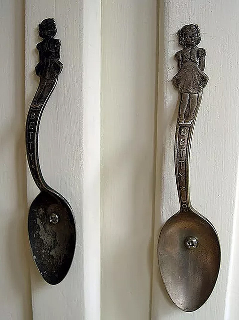 two dark gray spoon door knobs