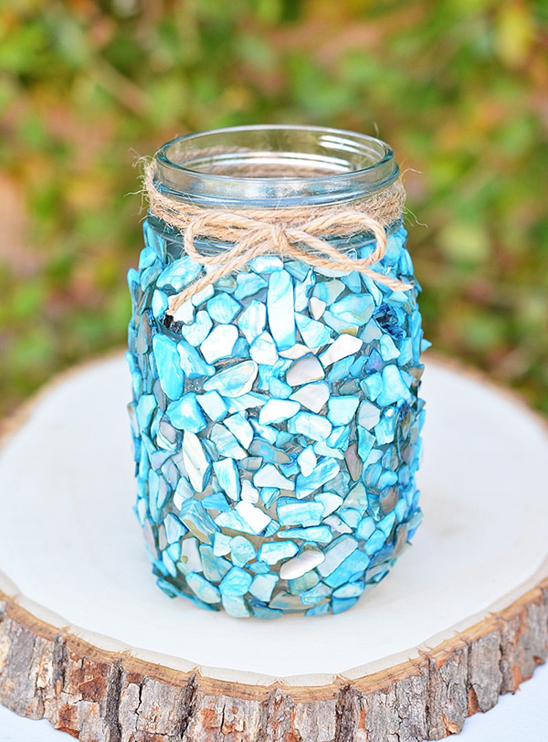 blue glass vase on log