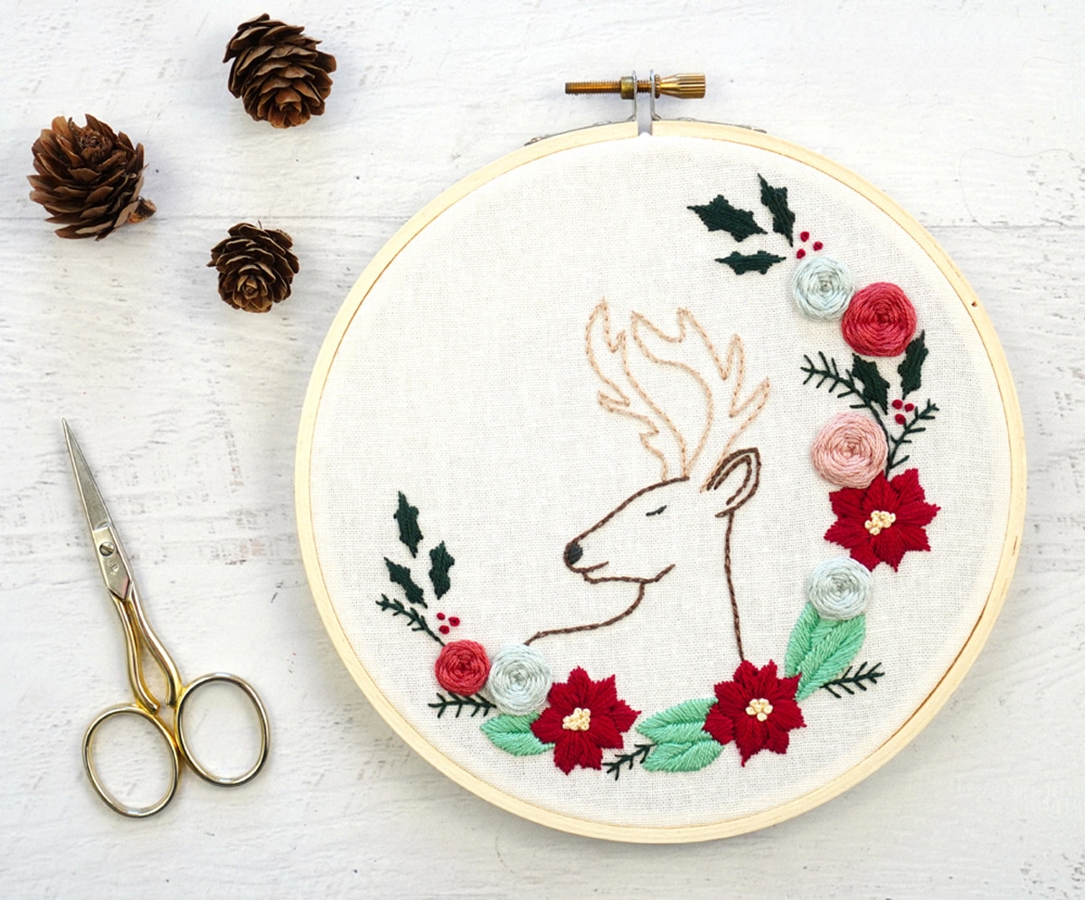 charming Christmas deer embroidery pattern next to scissors