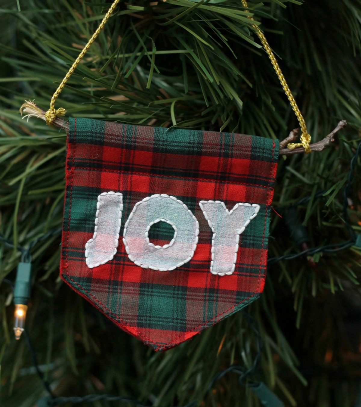 embroidered decorative flags hang on Christmas tree