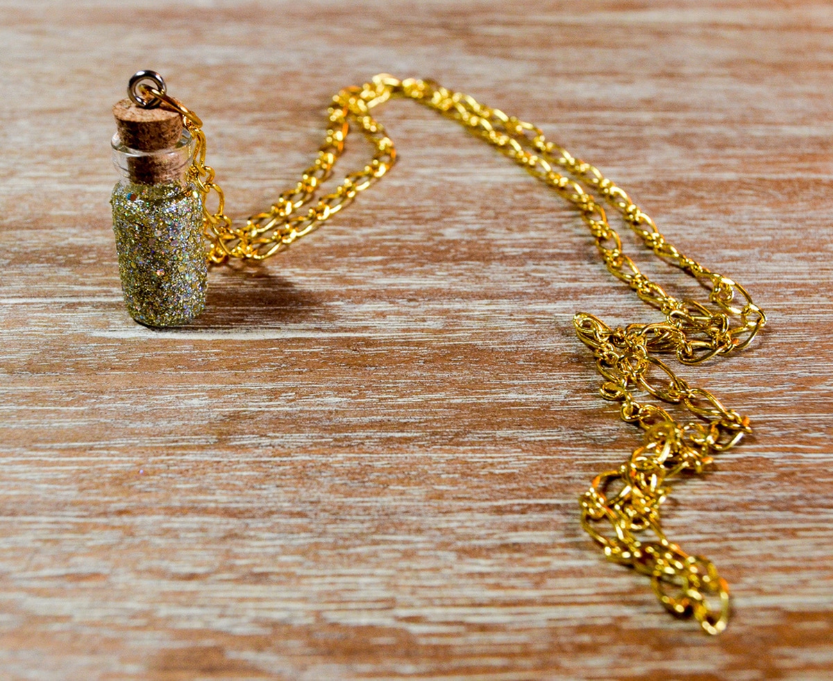fairy dust necklace on wooden table