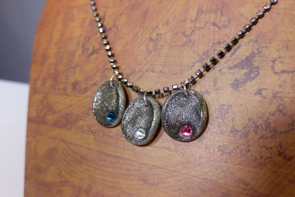 fingerprint birthstone necklace on table