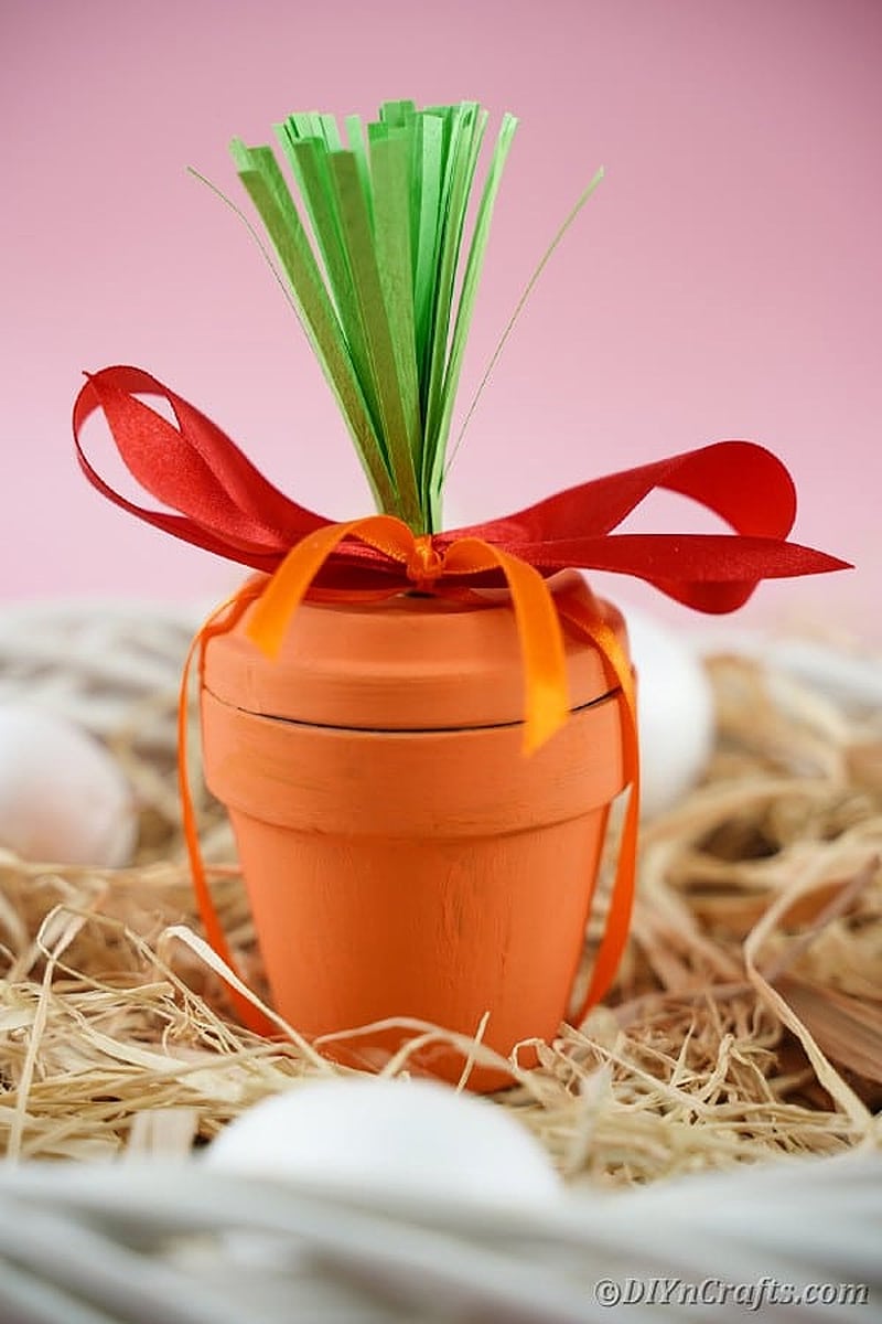 whimsical carrot-shaped flower pot painted in vibrant orange