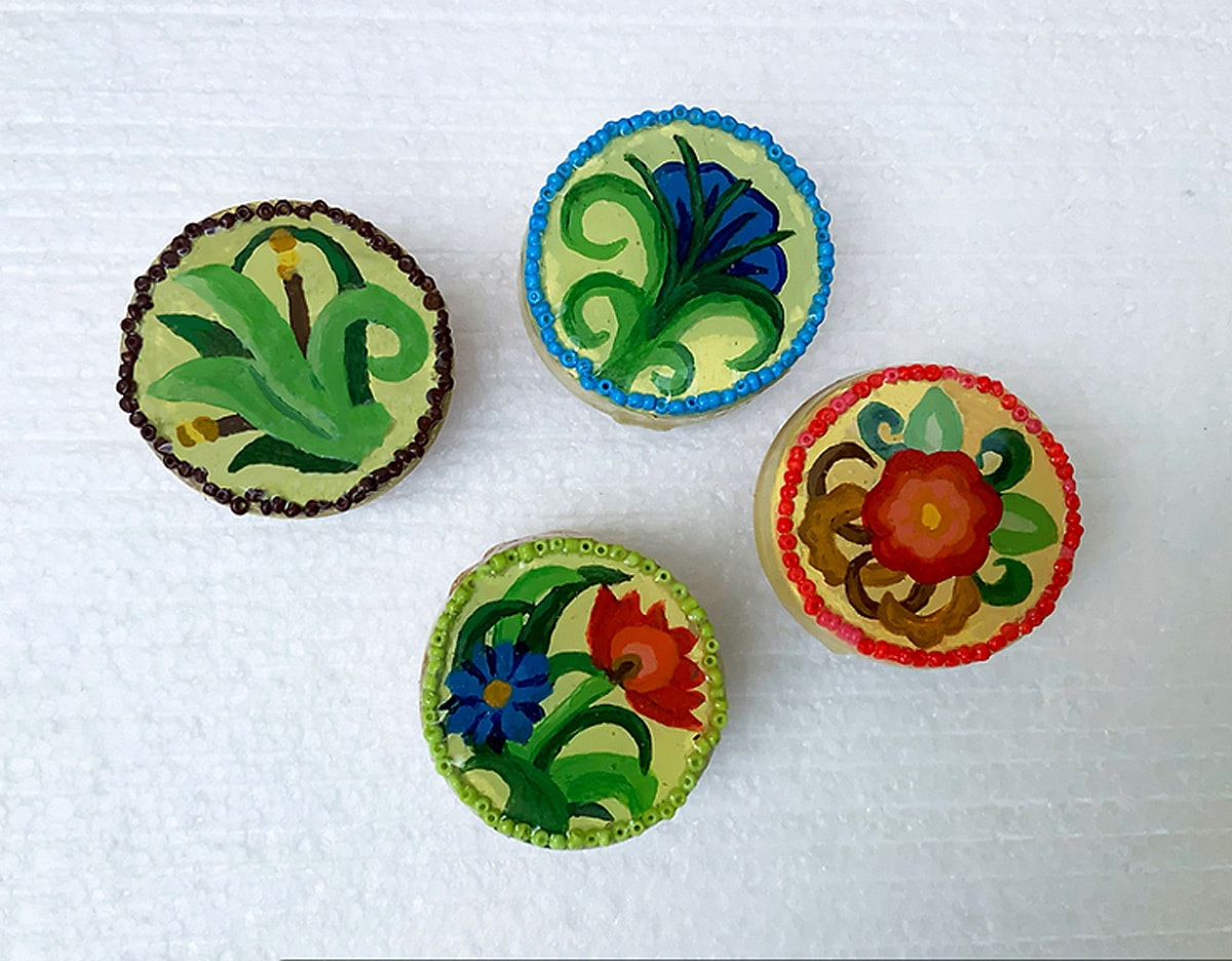four colorful flower-shaped knobs