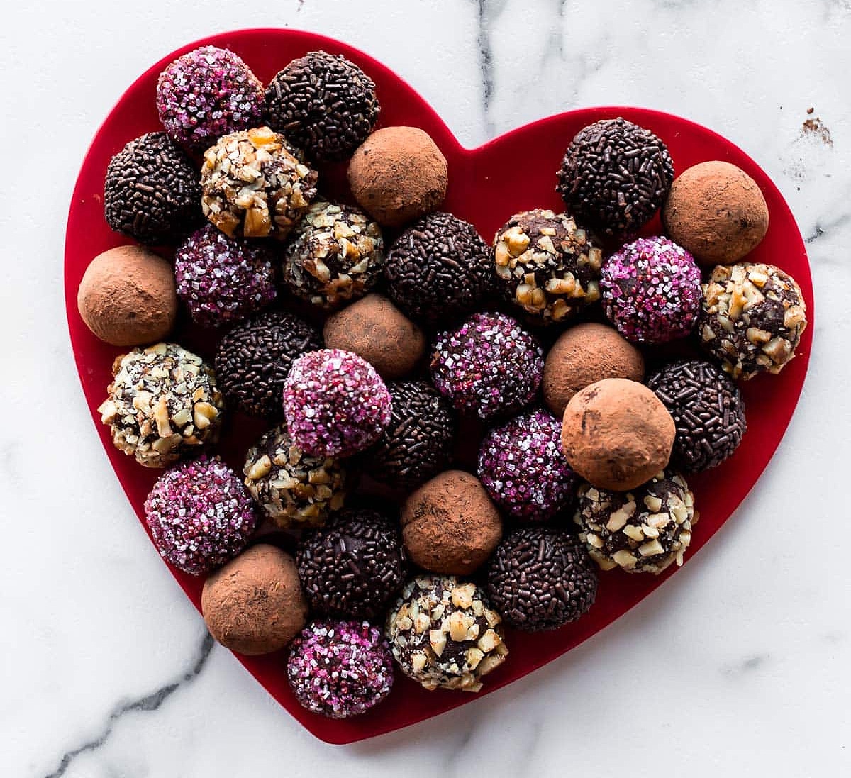 heart-shaped plate of chocolate truffles