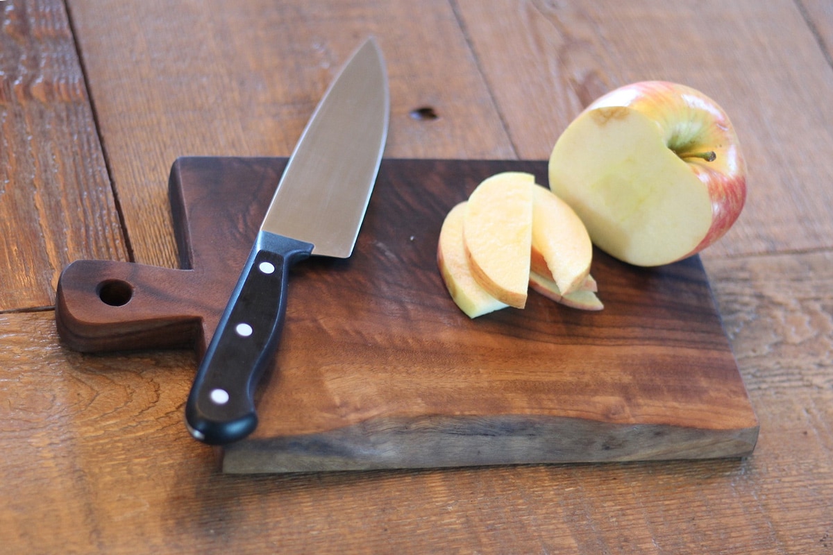 cut apple on wooden cutting board