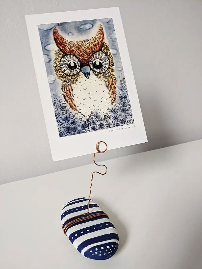 rock holding photo has image of an owl