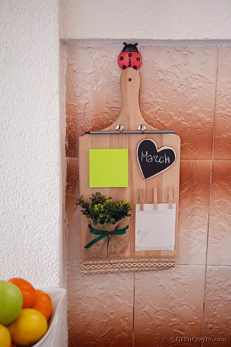 upcycled wooden cutting board hung on wall