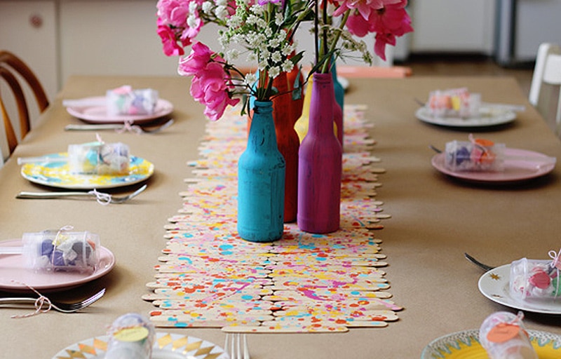 popsicle sticks splatter-painted with vibrant colors