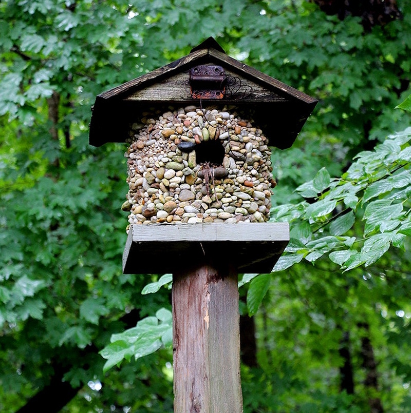 stone-covered birdhouse