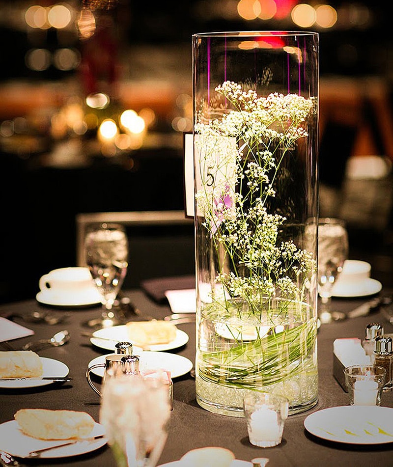 tree branches in glass vase on table