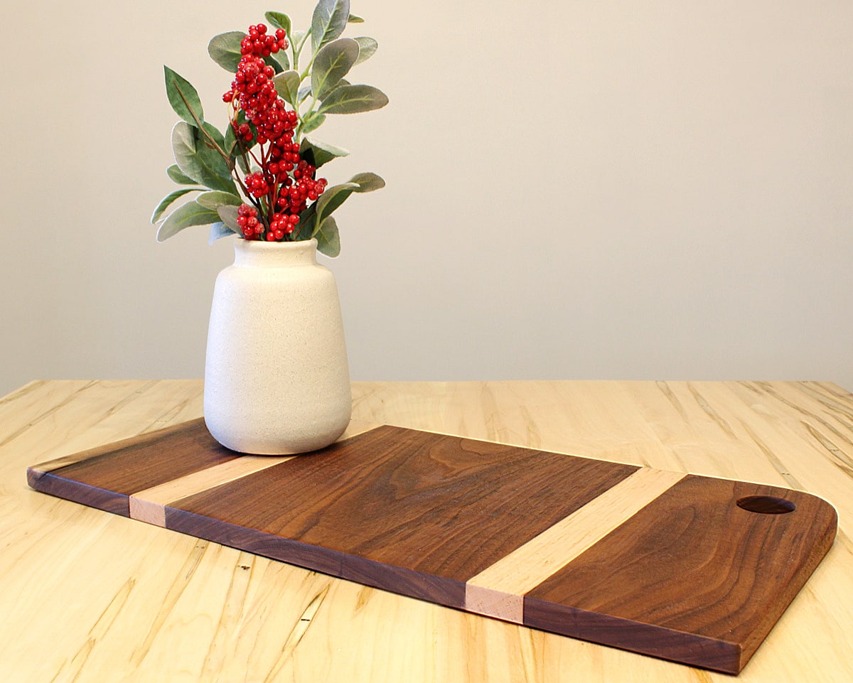 two-tone wooden cutting board and vase