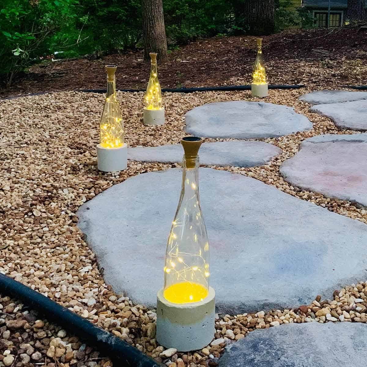wine bottle lights with pretty cement bases