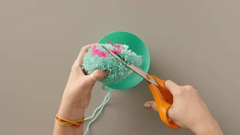 crafting colorful yarn pom poms