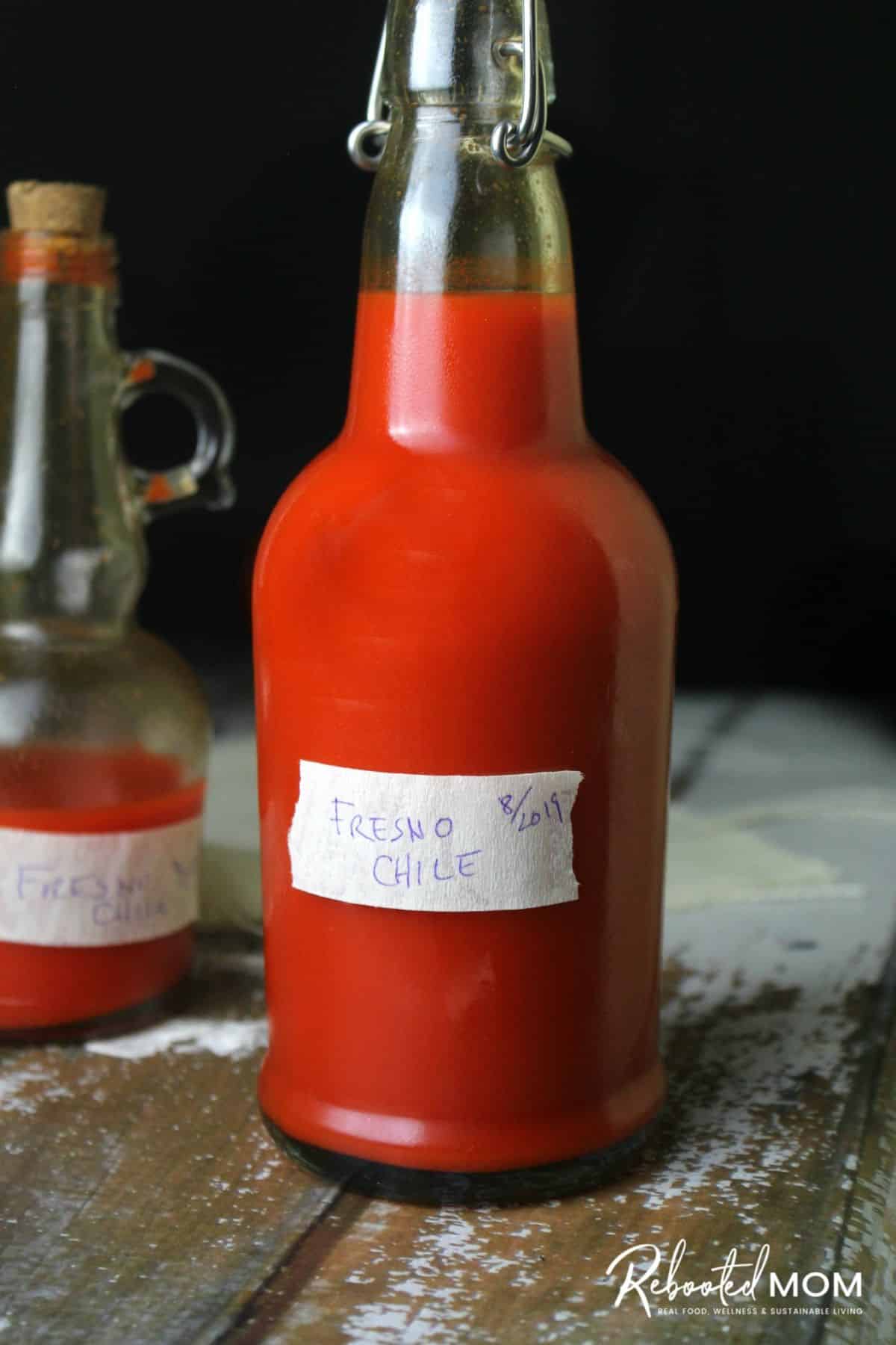 Fermented Fresno Pepper Hot Sauce in a glass jar.